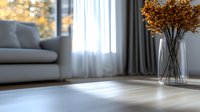 Minimalist living room interior with autumn dried flowers in glass vase, gray sofa, and natural sunlight casting shadows through sheer curtains on wooden floor.