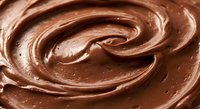 Rich creamy chocolate spread swirled in smooth spiral pattern, perfect for dessert backgrounds, confectionery marketing, and culinary design projects.