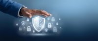 Businessman hand protecting digital security shield with lock icons representing cybersecurity, data protection and privacy safeguarding technology.
