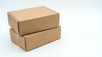 Two stacked brown cardboard shipping boxes on white background for packaging and delivery services.