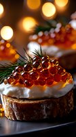 Luxurious red caviar canape on toasted bread with cream and fresh dill garnish against festive bokeh lights background, macro food photography.