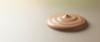 Creamy beige swirl of cosmetic foundation or moisturizer on neutral surface, suitable for beauty and skincare product marketing.