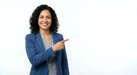 Professional Hispanic businesswoman in blue blazer pointing finger gesture on white background isolated for presentations and marketing materials.