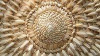 Intricate circular pattern of woven wheat stalks arranged in traditional decorative style, featuring natural golden tones and detailed spiral design. Suitable for rustic decor themes.