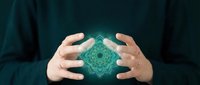 Hands protecting glowing green mandala energy sphere with sacred geometry patterns for spiritual healing and meditation practices.