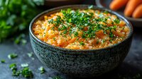 Creamy carrot risotto garnished with fresh parsley in rustic ceramic bowl, vibrant orange color with textured rice grains and seasonal vegetables.