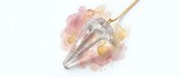 Crystal pendulum with rose quartz and amethyst stones on gold chain, isolated on white background for jewelry design and spiritual wellness product use.