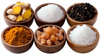 Wooden bowls with cooking ingredients including turmeric root, sea salt, black peppercorns, curry powder, rock sugar crystals and coarse salt on white background.