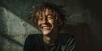Happy young woman with curly hair laughing joyfully in natural sunlight shadows, authentic emotion and positive energy for lifestyle content.
