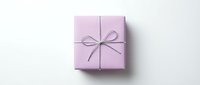 Purple gift box with ribbon bow on white background isolated for holiday celebration design.
