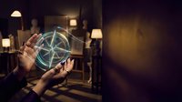 Hands holding glowing geometric hologram sphere in dark room with warm lighting, representing technology, innovation, and digital transformation for business concepts.