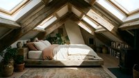 Cozy attic bedroom with wooden beams, skylights, and natural light. Comfortable bed with neutral bedding, potted plants, and rustic decor for relaxation and sleep.
