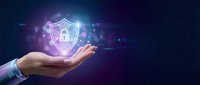 Hand holding glowing neon shield with padlock icon, representing cybersecurity, data protection, and digital safety solutions for business and technology.