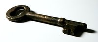 Antique brass skeleton key with ornate loop handle and aged patina, isolated on white background, suitable for vintage design, steampunk projects, and historical illustrations.