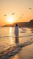 Woman in white dress standing in ocean waves at golden sunset with seagulls flying overhead, arms outstretched in freedom and joy on peaceful beach.
