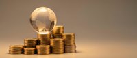 Global financial growth concept with golden coins stacked in ascending piles and transparent globe representing worldwide economy and investment success.