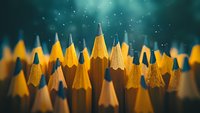 Sharp yellow pencils arranged in rows against dark teal background with bokeh light effects create artistic composition for education and creativity concepts.