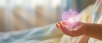Hand holding glowing neon heart symbol, representing love, care, charity, and compassion for healthcare and wellness concepts.