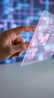 Hand touching transparent digital interface with data visualization and holographic display for futuristic technology applications.