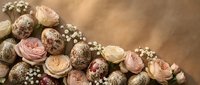 Elegant floral arrangement with soft pink and cream roses, decorative spheres and baby's breath on warm beige background for wedding decor.