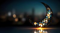 Decorative crescent moon lantern with stained glass floral pattern glowing warmly against dark blurred city skyline background creating magical atmosphere.