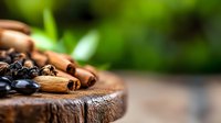 Aromatic cinnamon sticks and roasted coffee beans on rustic wooden board with blurred green background, macro food photography for cafe and culinary designs.