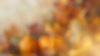 Abstract autumn bokeh background with warm orange and golden light effects creating soft blurred circles and dreamy atmosphere for seasonal designs.