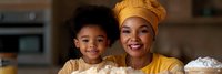 African American mother and daughter baking together in modern kitchen wearing matching yellow outfits, sharing joyful bonding moment during cooking activity.