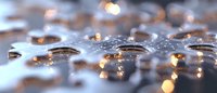 Water drops on reflective surface with golden bokeh lights creating magical atmosphere. Macro photography captures crystalline purity and light refraction.