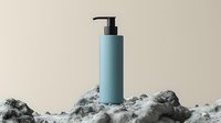Minimalist blue cosmetic pump bottle on abstract rocky terrain against beige background. Luxury skincare packaging mockup for beauty product presentation.