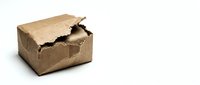 Damaged crushed cardboard box isolated on white background, depicting poor packaging, shipping damage, and delivery failure concept.