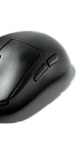 Black wireless computer mouse with side buttons isolated on white background, close-up macro shot for tech and office design use.