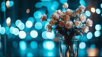 Delicate white roses in glass vase against blurred turquoise bokeh lights background creating romantic mood and dreamy atmosphere for special occasions.