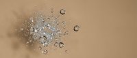 Water droplets splashing on beige surface creating dynamic motion with crystal clear bubbles and ripples for skincare and cosmetic applications.