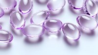 Transparent purple gel capsules scattered on white surface with soft shadows, macro photography showing pharmaceutical details and reflective properties.