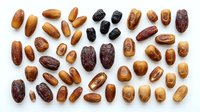 Assorted dates collection showing various types and sizes of dried fruit on white background isolated for healthy snacking and cooking designs.