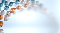 Elegant pearl and crystal beaded strands in soft blue, peach and white colors creating graceful curves against blurred light background. Suitable for jewelry design.