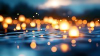 Glowing lanterns floating on dark water surface create magical bokeh effect with warm orange lights reflecting against rippling blue waves at dusk.