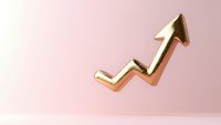 Golden upward trending arrow on soft pink background symbolizing growth, success and positive financial performance in business and economy.