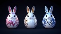 Decorative ceramic bunnies with floral patterns in pink, brown and blue colors on white background against dark surface. Easter holiday collection.