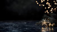 Festive winter composition with golden straw star ornament and spruce branches on dark background with bokeh lights and copy space for seasonal designs.
