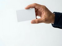 Male hand holding blank white business card isolated on white background, ready for branding and corporate identity design.
