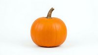 Isolated orange pumpkin with brown stem on white background, ready for autumn designs, fall decorations, Halloween projects, and seasonal marketing materials.