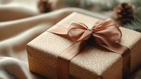 Elegant gift box wrapped in polka dot paper with satin rose gold bow on blurred festive background with pine cones and soft fabric, holiday celebration concept.