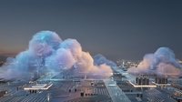 Massive colorful smoke clouds billow over urban cityscape during daytime, creating surreal atmospheric effect above buildings and streets for conceptual, editorial, or artistic projects.