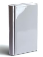 White hardcover book with blank cover standing upright on white background, isolated mockup for publishing and design projects.