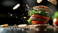 Levitating burger with fresh ingredients and sesame bun exploding with crumbs and seeds in dynamic composition against dark background. Food photography for menu design.