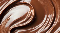 Swirling milk and dark chocolate creating smooth waves and ripples with glossy texture and rich brown tones, suitable for confectionery and dessert marketing.