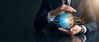 Businessman holding glowing digital brain with neural network connections, representing artificial intelligence, innovation, and technology solutions for business growth.