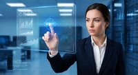 Professional businesswoman interacting with futuristic holographic interface displaying data analytics and charts in modern corporate office environment.